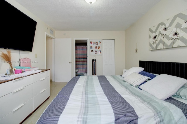 8095 NW 8th St Unit 209, Miami, FL 33126 - bedroom featuring a textured ceiling and light tile patterned floors