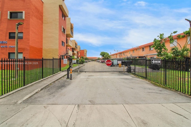 8095 NW 8th St Unit 209, Miami, FL 33126 - view of concrete street featuring a gated entry, a gate, and a residential view