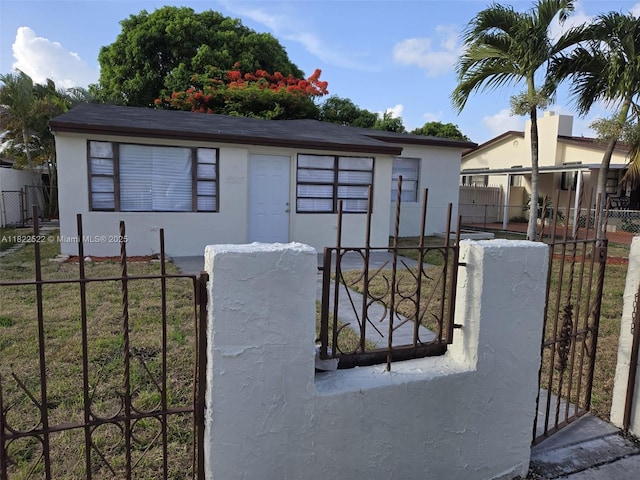 257 E 38th St, Hialeah, FL 33013 - single story home featuring a gate, a fenced front yard, and stucco siding