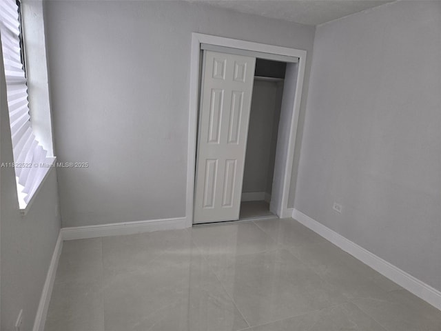 257 E 38th St, Hialeah, FL 33013 - unfurnished bedroom with tile patterned floors and a closet