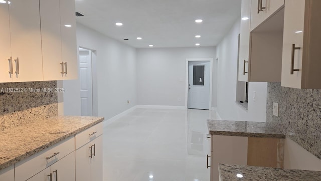 257 E 38th St, Hialeah, FL 33013 - kitchen with light stone counters, tasteful backsplash, recessed lighting, and white cabinetry