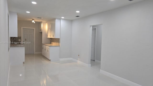 257 E 38th St, Hialeah, FL 33013 - kitchen with tasteful backsplash, white cabinetry, and recessed lighting