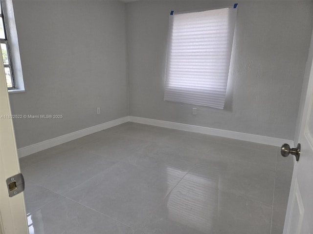 257 E 38th St, Hialeah, FL 33013 - tiled empty room featuring baseboards