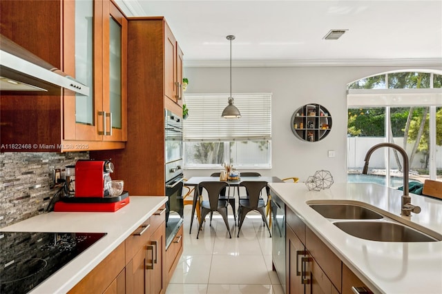 1745 NW 77th Ave, Pembroke Pines, FL 33024 - kitchen featuring black electric cooktop, exhaust hood, backsplash, light countertops, and brown cabinets