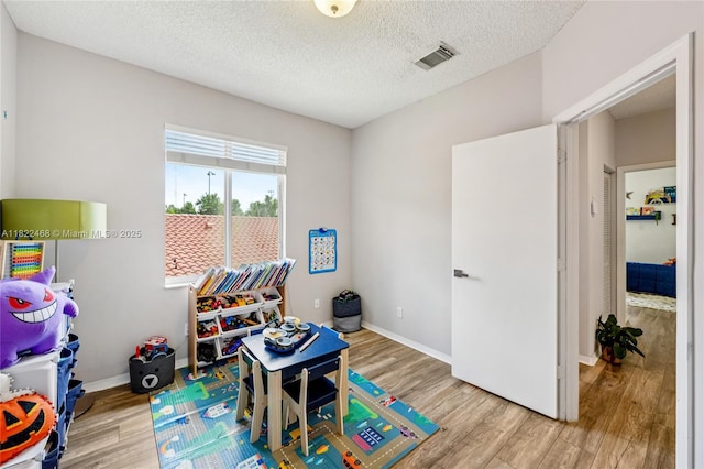 1745 NW 77th Ave, Pembroke Pines, FL 33024 - rec room featuring wood finished floors and a textured ceiling