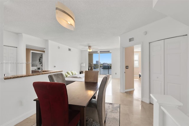 17100 N Bay Rd Unit 1904, Sunny Isles Beach, FL 33160 - dining area featuring ceiling fan, a textured ceiling, and light tile patterned floors
