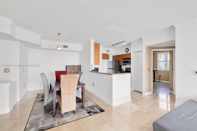 17100 N Bay Rd Unit 1904, Sunny Isles Beach, FL 33160 - dining room featuring a textured ceiling, track lighting, and light tile patterned floors