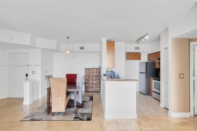 17100 N Bay Rd Unit 1904, Sunny Isles Beach, FL 33160 - dining area featuring a textured ceiling, light tile patterned floors, and track lighting