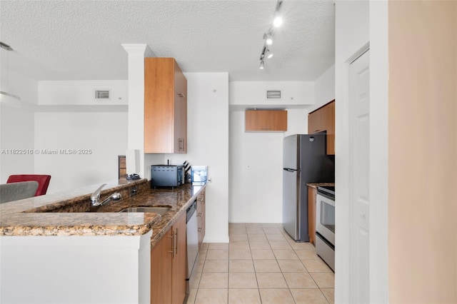 17100 N Bay Rd Unit 1904, Sunny Isles Beach, FL 33160 - kitchen featuring stainless steel appliances, a peninsula, light tile patterned flooring, a textured ceiling, and dark stone counters