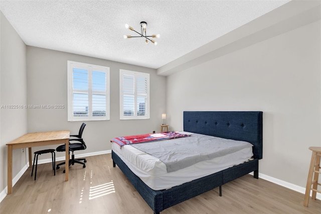 17100 N Bay Rd Unit 1904, Sunny Isles Beach, FL 33160 - bedroom with a chandelier, a textured ceiling, and light wood finished floors