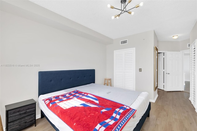 17100 N Bay Rd Unit 1904, Sunny Isles Beach, FL 33160 - bedroom featuring wood finished floors and a chandelier