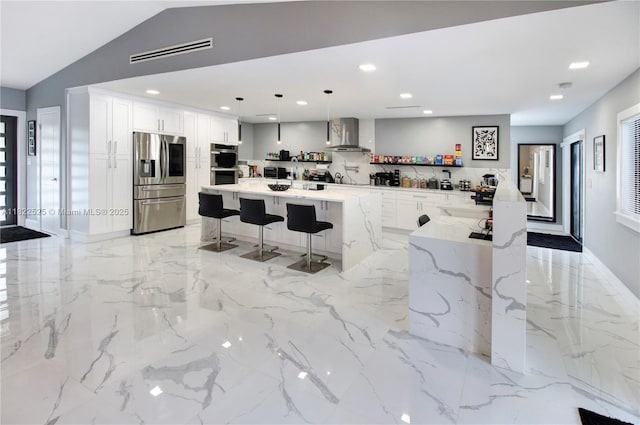 11044 NW 19th Mnr, Coral Springs, FL 33071 - kitchen with appliances with stainless steel finishes, wall chimney exhaust hood, a breakfast bar, recessed lighting, and light marble finish floors