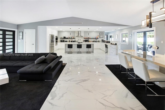 11044 NW 19th Mnr, Coral Springs, FL 33071 - living area featuring vaulted ceiling, light marble finish flooring, french doors, and recessed lighting