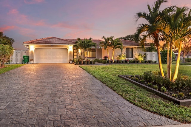 11044 NW 19th Mnr, Coral Springs, FL 33071 - mediterranean / spanish home with decorative driveway, a garage, a tiled roof, and stucco siding