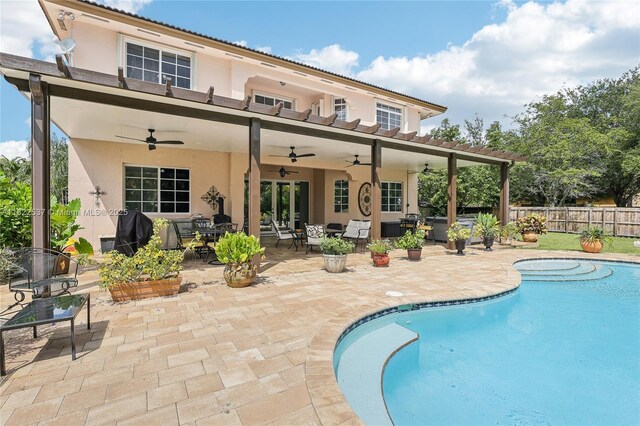 13006 SW 196th St, Miami, FL 33177 - back of property featuring stucco siding, a ceiling fan, outdoor dining space, and a patio