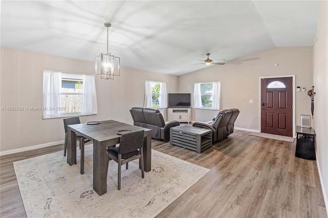 1712 Melvin Ave, Orlando, FL 32806 - dining space with lofted ceiling, light wood-type flooring, ceiling fan, and a chandelier