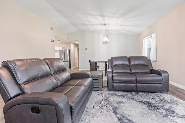 1712 Melvin Ave, Orlando, FL 32806 - living room featuring a chandelier and wood finished floors