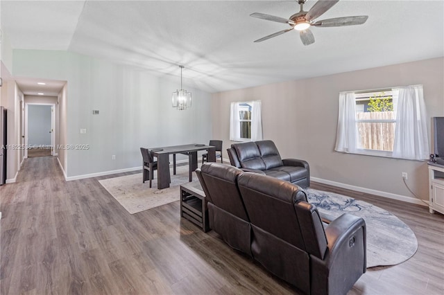 1712 Melvin Ave, Orlando, FL 32806 - living area with a chandelier, a ceiling fan, and wood finished floors