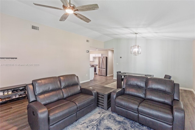 1712 Melvin Ave, Orlando, FL 32806 - living room featuring wood finished floors, a ceiling fan, a chandelier, and lofted ceiling