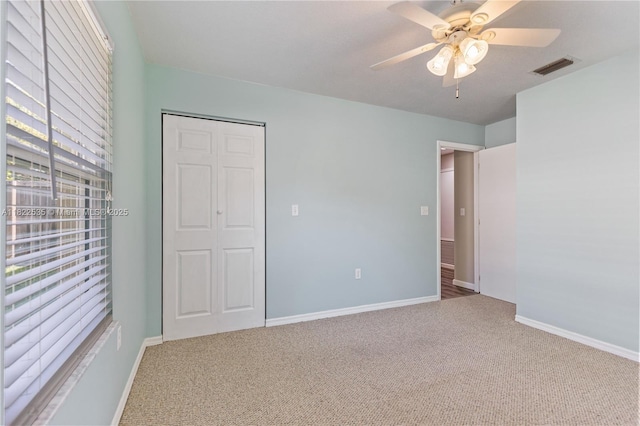 1712 Melvin Ave, Orlando, FL 32806 - unfurnished bedroom with carpet, a closet, and a ceiling fan