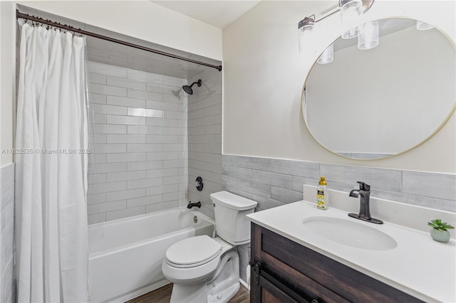 1712 Melvin Ave, Orlando, FL 32806 - bathroom featuring shower / bathtub combination with curtain, vanity, tile walls, a wainscoted wall, and wood finished floors