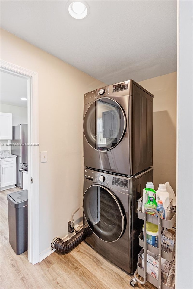 1712 Melvin Ave, Orlando, FL 32806 - washroom featuring estacked washer and dryer and light wood-type flooring