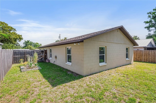 1712 Melvin Ave, Orlando, FL 32806 - rear view of property featuring a fenced backyard, concrete block siding, and a garden