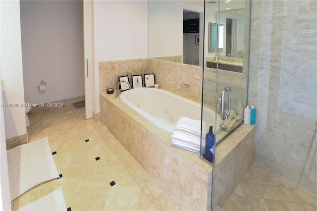 1425 Brickell Ave Unit 48C, Miami, FL 33131 - bathroom featuring a whirlpool tub, a stall shower, and tile patterned flooring
