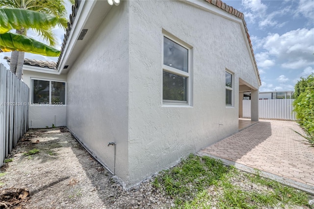 9408 SW 156th Pl, Miami, FL 33196 - view of home's exterior with stucco siding, a patio, and a tile roof