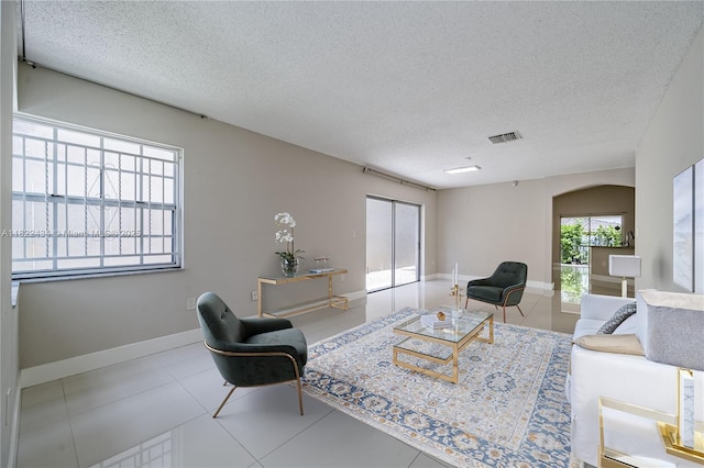 9408 SW 156th Pl, Miami, FL 33196 - tiled living area featuring a textured ceiling and arched walkways