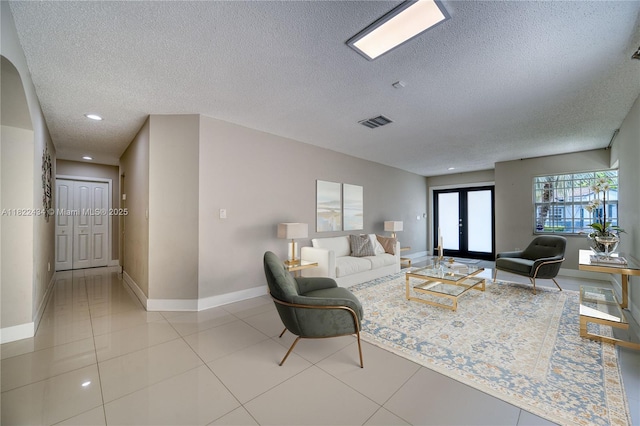 9408 SW 156th Pl, Miami, FL 33196 - living room featuring a textured ceiling, french doors, recessed lighting, and tile patterned floors