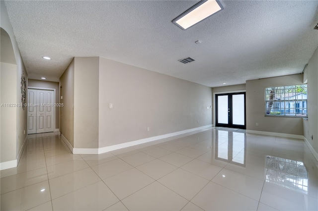 9408 SW 156th Pl, Miami, FL 33196 - empty room featuring a textured ceiling, french doors, light tile patterned floors, and recessed lighting