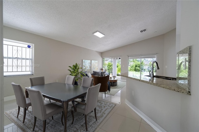 9408 SW 156th Pl, Miami, FL 33196 - dining area with lofted ceiling, light tile patterned floors, and a textured ceiling