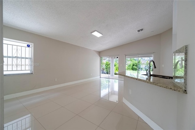 9408 SW 156th Pl, Miami, FL 33196 - spare room with lofted ceiling, a textured ceiling, and light tile patterned flooring