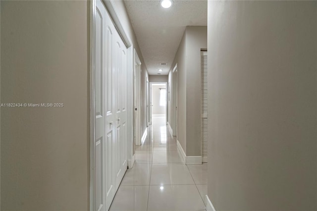 9408 SW 156th Pl, Miami, FL 33196 - hallway featuring a textured ceiling and light tile patterned floors