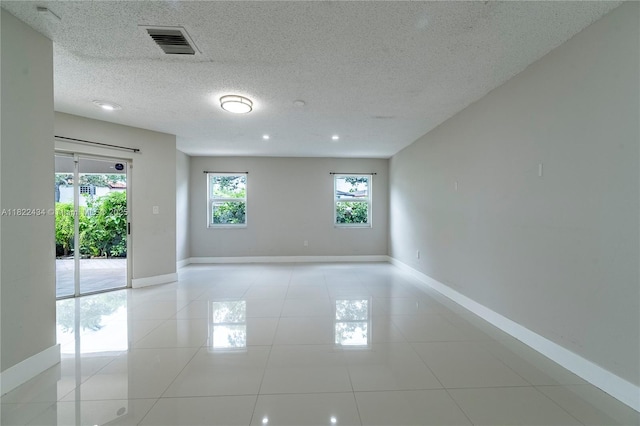 9408 SW 156th Pl, Miami, FL 33196 - spare room featuring light tile patterned flooring and a textured ceiling