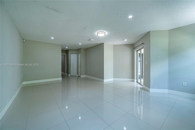 9408 SW 156th Pl, Miami, FL 33196 - unfurnished room featuring a textured ceiling, light tile patterned floors, and recessed lighting