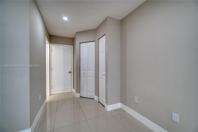 9408 SW 156th Pl, Miami, FL 33196 - hallway featuring a textured ceiling and tile patterned floors