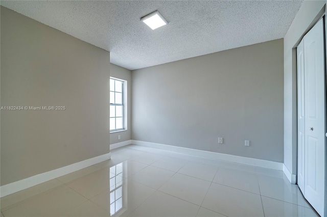9408 SW 156th Pl, Miami, FL 33196 - empty room featuring a textured ceiling and tile patterned flooring