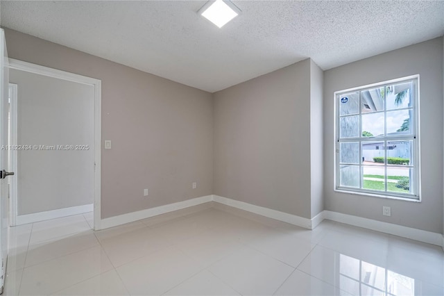 9408 SW 156th Pl, Miami, FL 33196 - unfurnished room featuring healthy amount of natural light, a textured ceiling, and light tile patterned floors