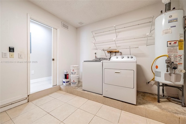 9408 SW 156th Pl, Miami, FL 33196 - washroom with water heater, washing machine and clothes dryer, tile patterned flooring, and a textured ceiling