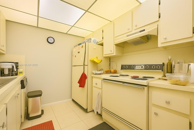 801 SW 133rd Ter Unit 308K, Pembroke Pines, FL 33027 - kitchen featuring white appliances, under cabinet range hood, light countertops, and light tile patterned floors