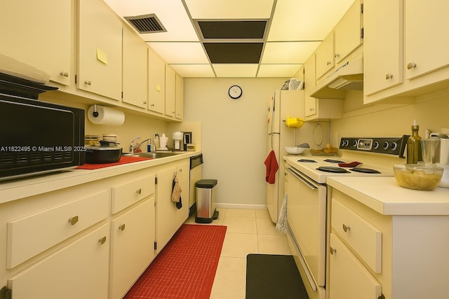 801 SW 133rd Ter Unit 308K, Pembroke Pines, FL 33027 - kitchen with electric range, light countertops, black microwave, dishwashing machine, and a paneled ceiling