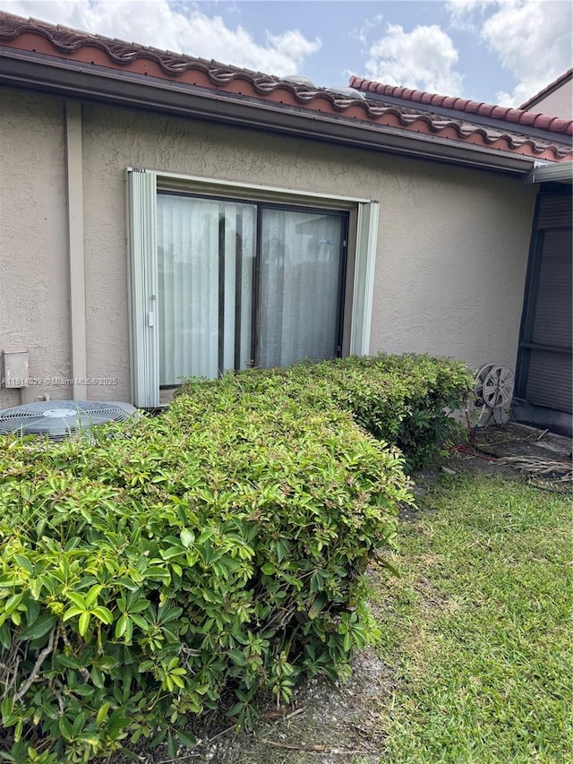 3313 W Inverrary Blvd W, Lauderhill, FL 33319 - view of property exterior with stucco siding and a tiled roof