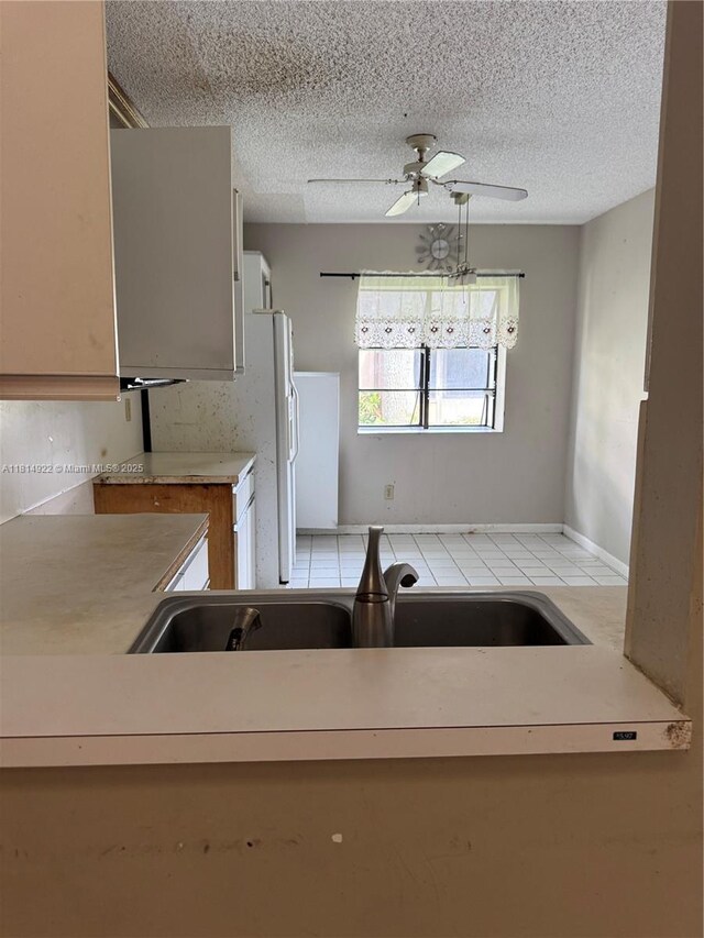 3313 W Inverrary Blvd W, Lauderhill, FL 33319 - kitchen with a ceiling fan, a textured ceiling, and light countertops