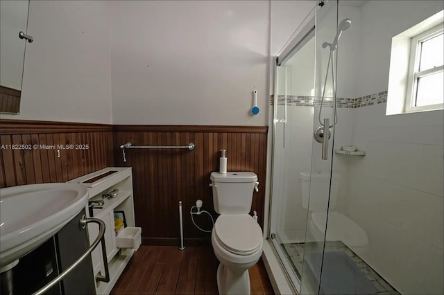 22115 SW 58th Ave, Boca Raton, FL 33428 - bathroom with a wainscoted wall, a stall shower, wood finished floors, and wood walls