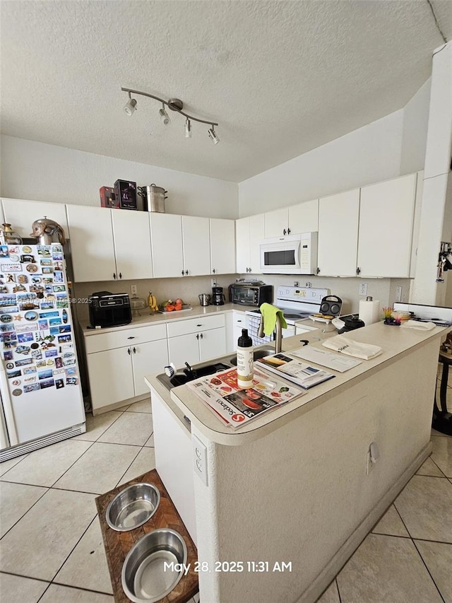11401 NW 76th Ter, Doral, FL 33178 - kitchen with white appliances, light tile patterned floors, light countertops, white cabinetry, and a textured ceiling