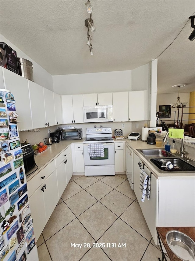 11401 NW 76th Ter, Doral, FL 33178 - kitchen featuring white appliances, light countertops, light tile patterned floors, white cabinets, and a peninsula