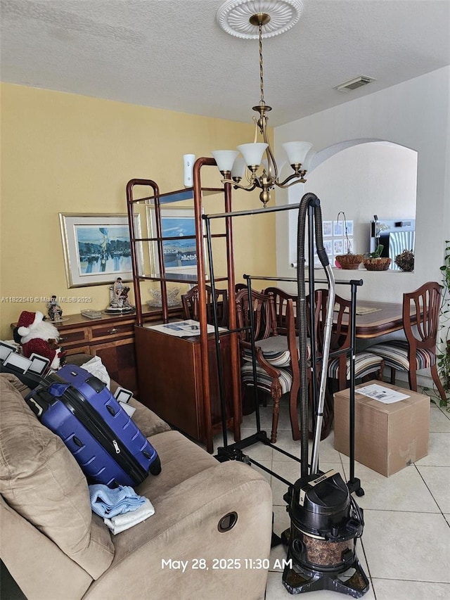 11401 NW 76th Ter, Doral, FL 33178 - tiled bedroom with a chandelier and arched walkways