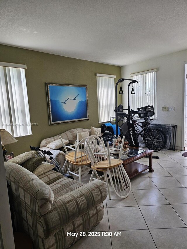 11401 NW 76th Ter, Doral, FL 33178 - tiled living room featuring healthy amount of natural light and a textured ceiling